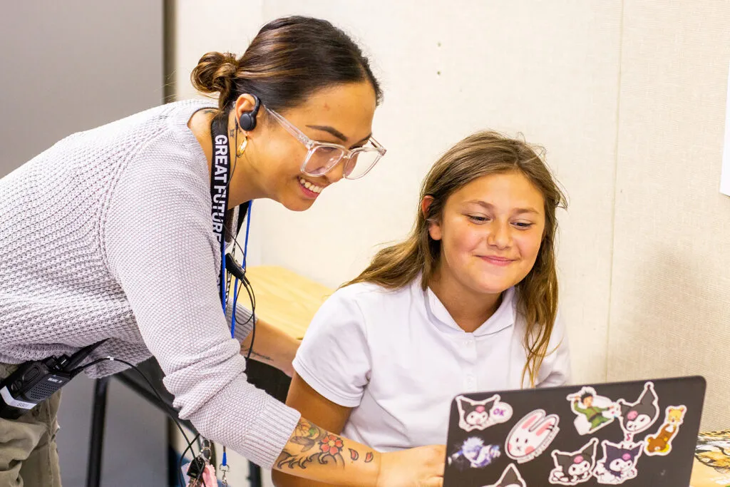 teacher and student at a computer